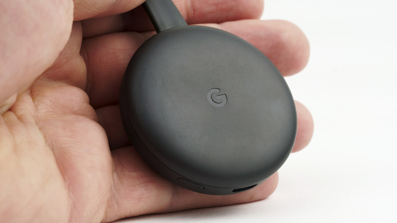 Hand holding Chromecast 