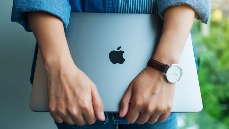 Woman holding a MacBook