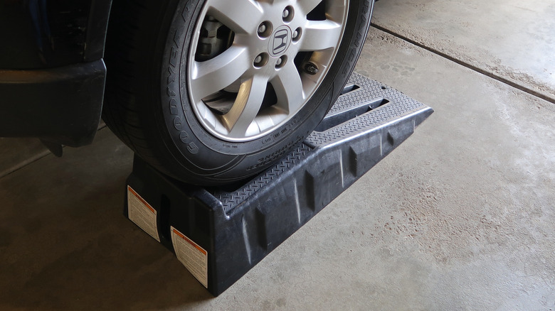 A red truck on a pair of car ramps