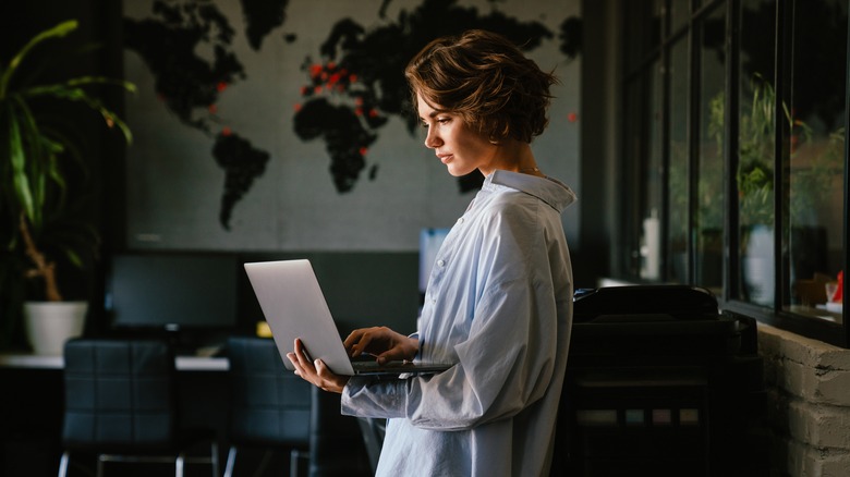 standing woman using a laptop