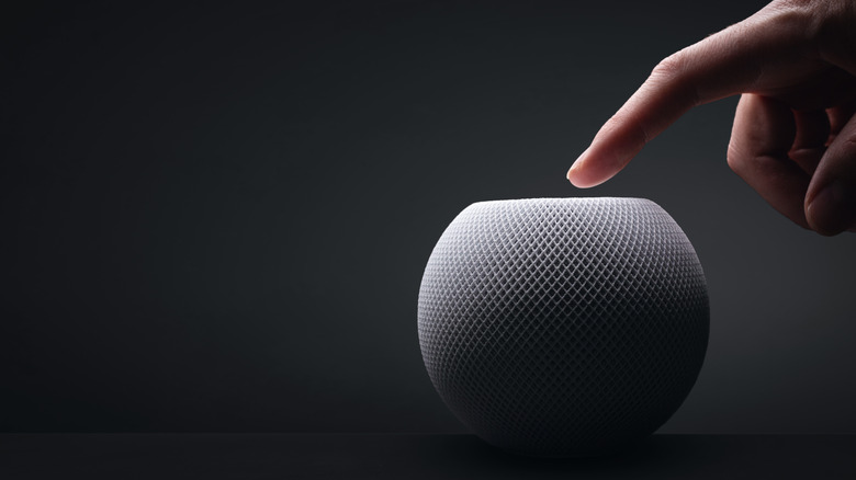 hand touching apple homepod