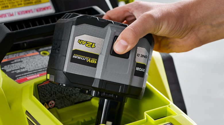 Person inserting Ryobi battery