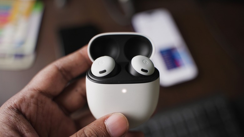 Google Pixel Buds in hand