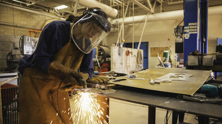 woman using a plasma cutter