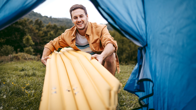 Camper sets up air mattress